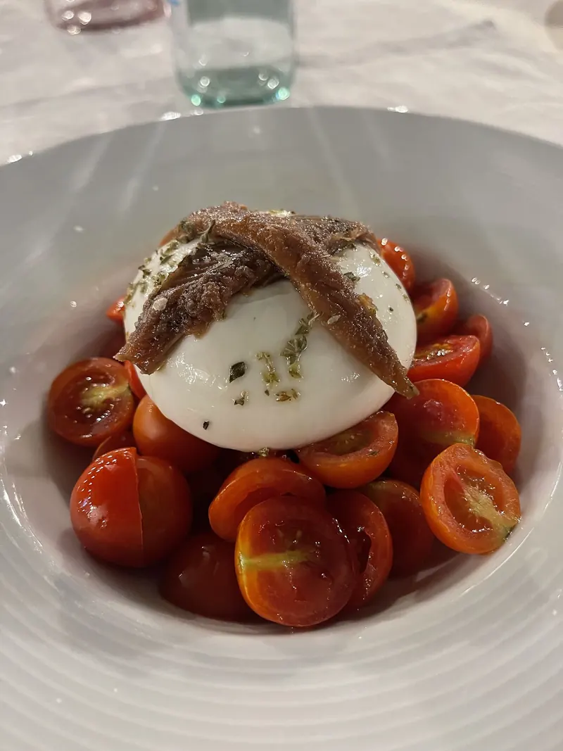Burrata with cherry tomatoes and anchovies
