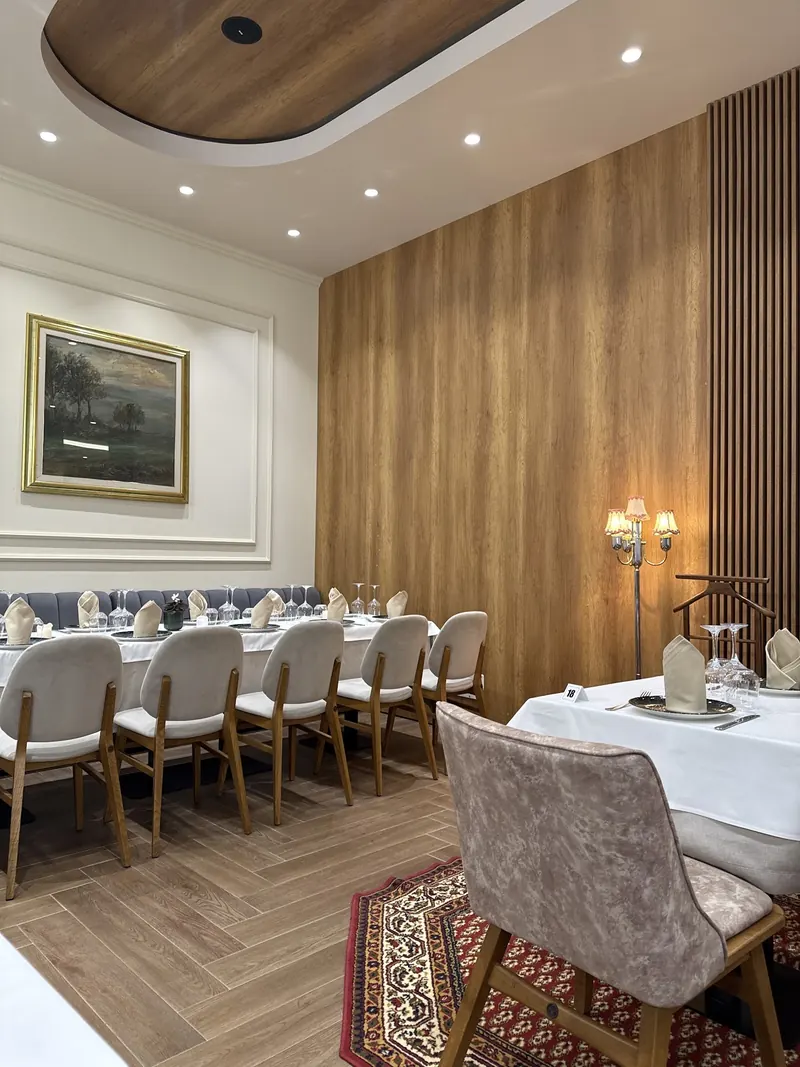 The Acqua Pazza dining room with wood panelling and laid tables